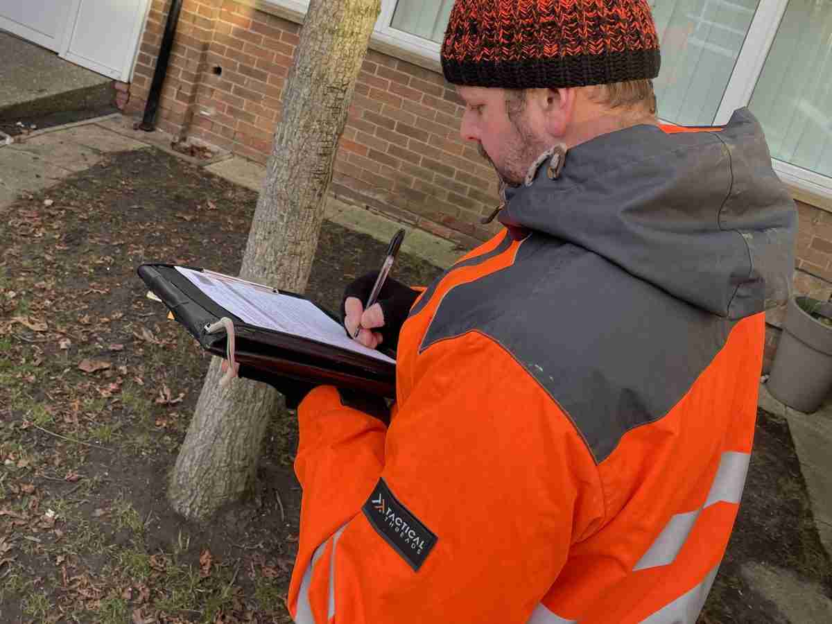 Andy with a clipboard collecting data for a tree survey at a North Tyneside school