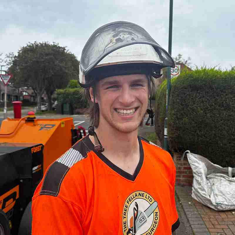 Man in orange top and helmet 
